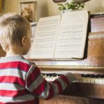 blonde boy playing piano at home 23 2147873697 150x150 - Violão Empenado? Dicas para manter seu instrumento livre de problemas!